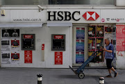 A man walks past by a closed HSBC bank branch in the UK.