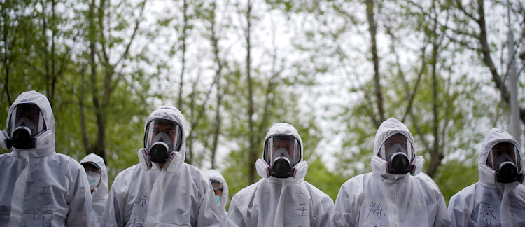 Volunteers from the Blue Sky Rescue team wearing protective suits in Wuhan, Hubei province, on April 2, 2020