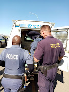 Two police officers were arrested after allegedly robbing a spaza shop in Kimberley.