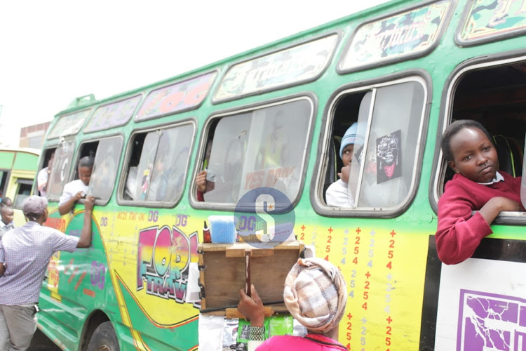 Students in a bus at Tea Room set to travel to school as they re-open for third term on August 29, 2023.