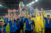 Leonardo Bonucci lifts the trophy as the Italians celebrate victory after Euro 2020 final against England at Wembley Stadium in London on July 11 2021.