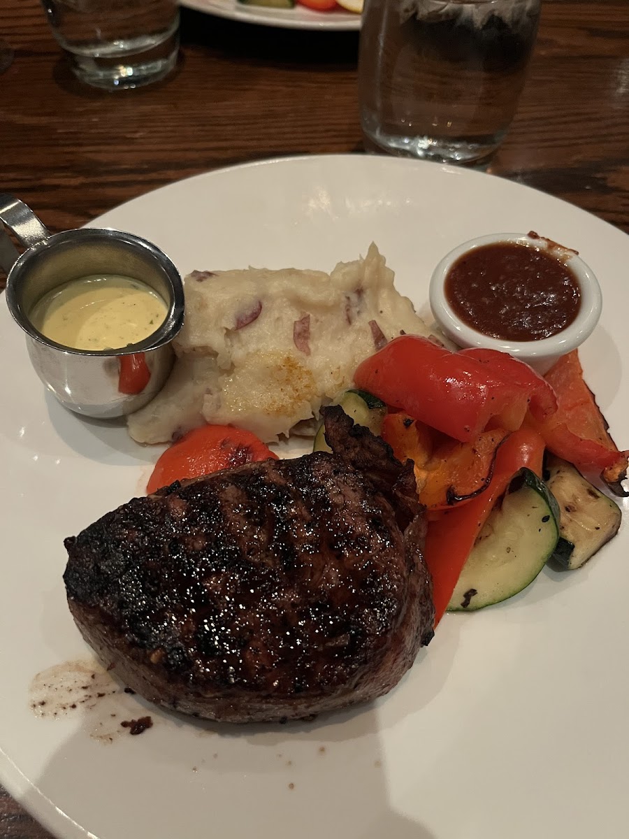 7oz fillet mignon with roasted vegetables and garlic mashed potatoes, and bernaise and bbq sauce on the side.