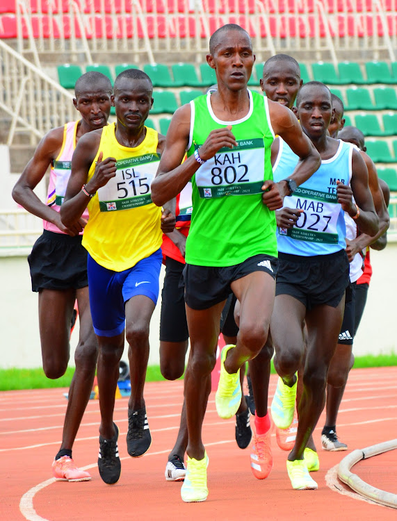 Collins Koros leads a pack of athletes during the men's 10,000m race yesterday.