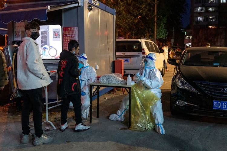 Residents queue for a PCR testing in Beijing, China, on Monday, November 21, 2022. Covid control restrictions now weigh on a fifth of China’s economy as infections continue their upward march, defying the central government’s call for more targeted, less disruptive Covid Zero measures.