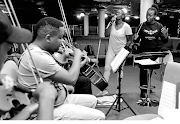 Ofentse Pitse, far right, rehearsing a number with her orchestra ensemble and with award-winning singer Judith Sephuma beside her. 

