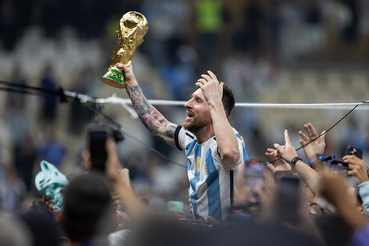 Lionel Messi of Argentina lifts the World Cup trophy as he celebrates Argentina beating France in the final at Lusail Stadium in Lusail City, Qatar on December 18 2022.