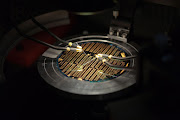 A file photograph of a microchip under test probes.
