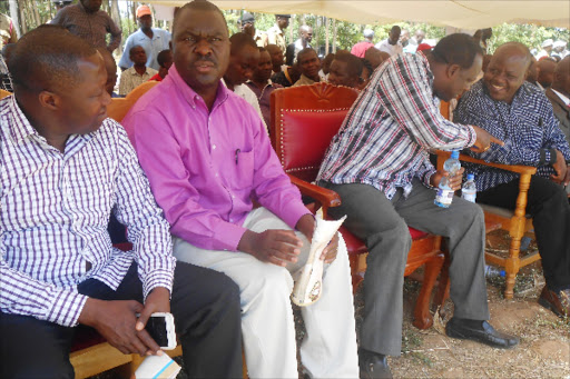 MPs Bernard Shinali and Emmanuel Wangwe discuss a point as governor Wycliffe Oparanya and Mumias East MP Ben Washiali share a point at Emakhwale village during the burial of former teacher Raphael Anguche alias RK on Saturday in Kakamega.photo Shaban Makokha