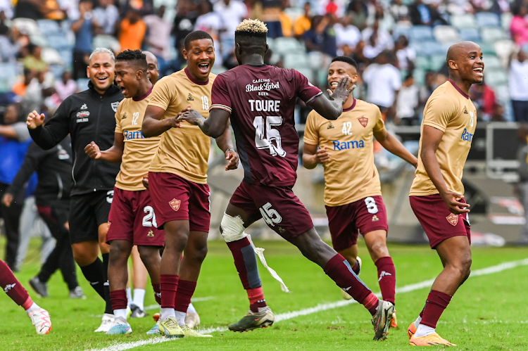 Stellenbosch FC player Ismael Toure celebrates with teammates after scoring during the Carling Knockout final match against TS Galaxy at Moses Mabhida Stadium on December 16, 2023.