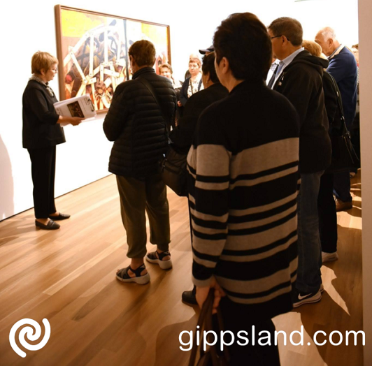 Gallery tour paticipants with volunteer Mary (2018)