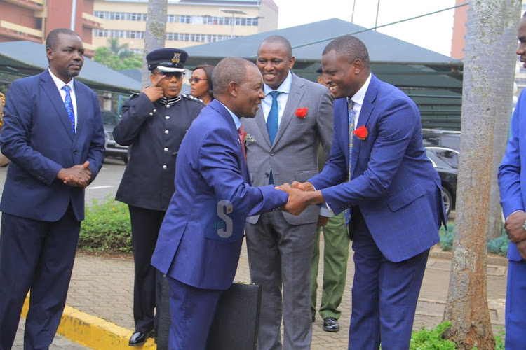 Treasury CS Njuguna Ndung’u greeting Kiharu MP Ndindi Nyoro when he arrived at Parliament ahead of the Budget Reading on June 15.