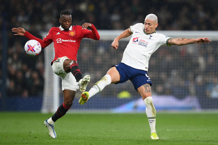 Richarlison of Tottenham Hotspur is put under pressure by Aaron Wan-Bissaka of Manchester United during their Premier League match at Tottenham Hotspur Stadium.