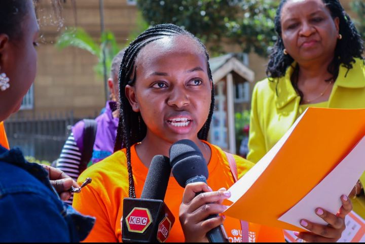 Winfred Odali, Strategic Litigation Lawyer at the Center for Rights Education and Awareness (CREAW) reading the petition to fellow protesters at the Supreme Court in Nairobi on Friday, December 9, 2022.