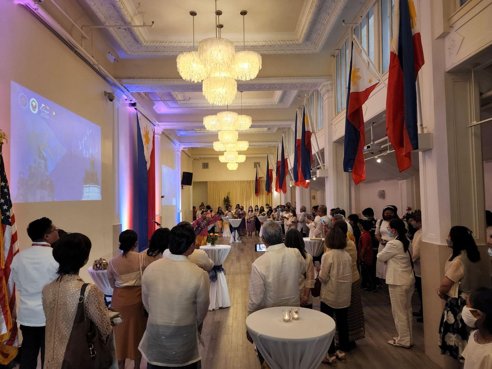 A group of people in a room with flags and flags

Description automatically generated with low confidence