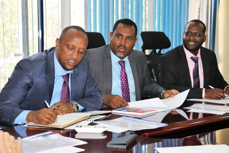 Governor Abdi Hassan Guyo , CEC for Lands Yussuf Dahir and chief officer Salad Kadubo on September 22, 2022.