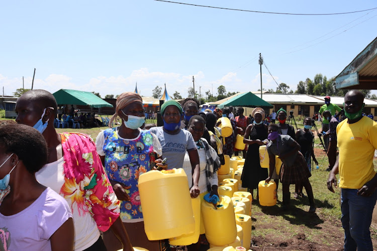 Members of the community at Imbo queue to fetch clean water facilitated by Mozzart Bet