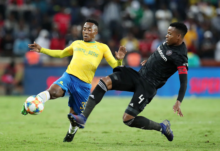 Mamelodi Sundowns forward Lebohang Maboe (L) is tackled by Orlando Pirates captain and defender Happy during a goalless Absa Premiership match at Orlando Stadium in Soweto on April 1 2019.