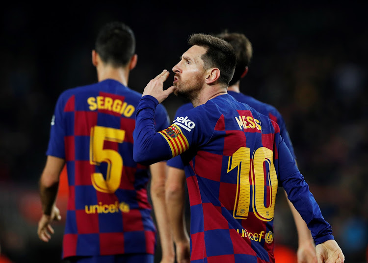 Barcelona's Lionel Messi celebrates scoring with teammates their third goal