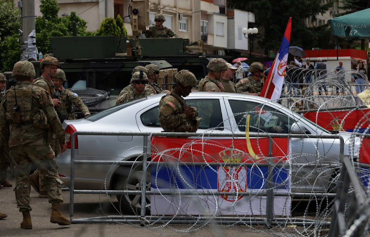 US Kosovo Force soldiers, under Nato, stand guard near a municipal office in Leposavic, Kosovo, on May 31 2023. Picture: FATOS BYTYCI/REUTERS