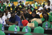 Delegates take their seats as they wait for the opening ceremony to start following issues with the accreditation process.