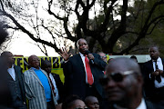 Former president Jacob Zuma addresses supporters in a park outside the state capture inquiry on Monday. 