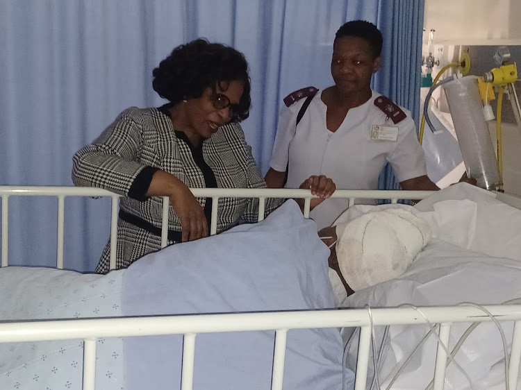 KwaZulu-Natal social development MEC Nonhlanhla Khoza lends support and comfort to primary school teacher Ngcinaphi Fakude who was attacked by her boyfriend Sakhiseni Nene with a panga on Monday.