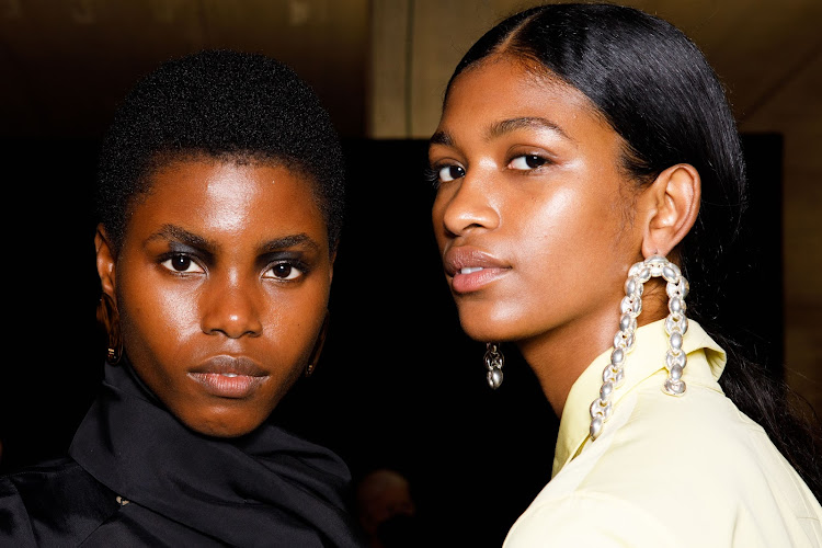 Models show off their curls and coils backstage at the Jil Sander fashion show.