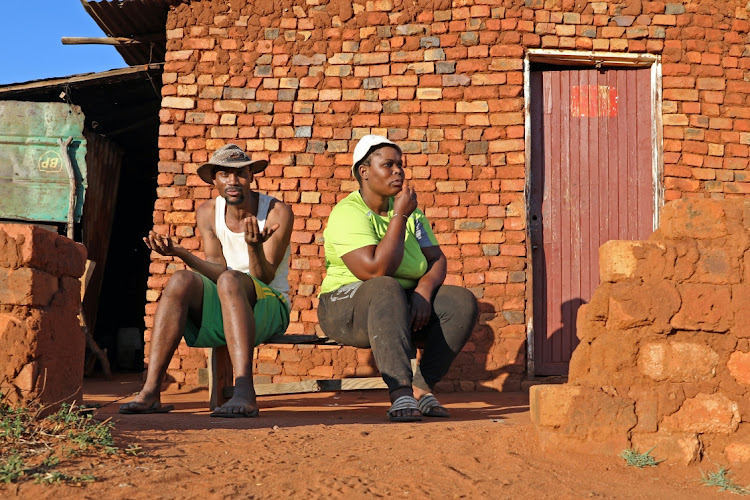 Thabiso Motaung sits outside his house alongside his girlfriend, Koketso Shiburi, in the Matebeleng village. While he believes some change may come from the elections, Shiburi has given up, saying no change could ever come to the forgotten village,