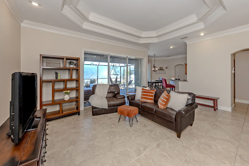 Living room with brown leather sofas - Prestige house for sale in North Port, 3 bedrooms