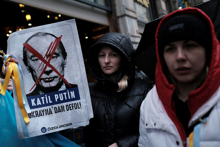 Ukrainians living in Turkey hold a protest against Russia's military operation in Ukraine, in front of the Russian Consulate in Istanbul, Turkey, on February 24 2022. The slogan on the poster reads that: "Murderer Putin. Get out of Ukraine!". Picture: REUTERS/MURAD SEZER