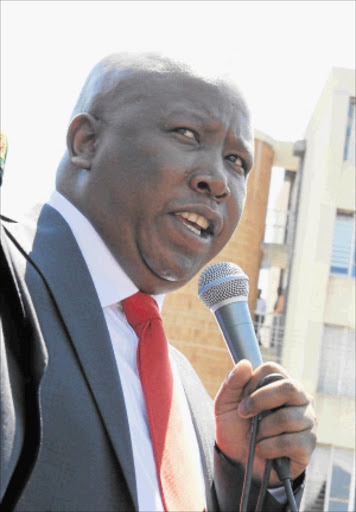 WORD OF CAUTION: Expelled ANCYL president Julius Malema addresses his supporters after his brief appearance in the Polokwane Regional Court on Wednesday. He urged his allies to be careful as there were people out to kill youth league members who had declared their support for him. PHOTO: ELIJAR MUSHIANA