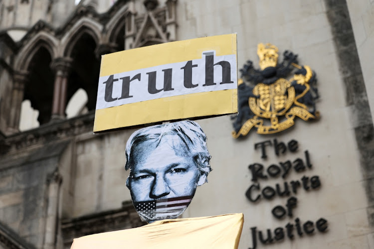 A view of a placard depicting WikiLeaks founder Julian Assange outside the high court on the day Assange appeals against his extradition to the US, in London, Britain, on February 20 2024. Picture: ISABEL INFANTES/REUTERS