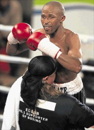 HOMECOMING: Trainer Nick Durandt lifts his charge Phumzile Matyhila after the fighter successfully defended his SA bantamweight title against Cleutus Mbhele recently. Photo: ALAN EASON