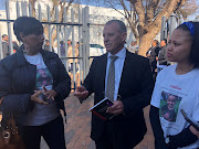 From left: Estelle Delport, spokesperson for the family of Liyaqat Mentoor who went missing in March this year, AfriForum Head of Private Prosecutions Advocate Gerrie Nel and a supporter of the Mentoor family in front of the the Roodepoort Magistrate’s Court on June 27, 2018. 