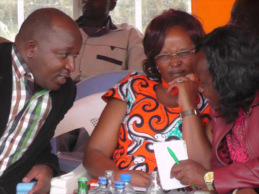 Laikipia East MP Anthony Mutahi, Laikipia County lands executive Ms Virginia Nderitu and Tigithi ward MCA Ms Beth Muchiri at Matanya Catholic church on Thursday during a consultative meeting on land matters. Land owners want issues concerning land grabbing be addressed once and for all.