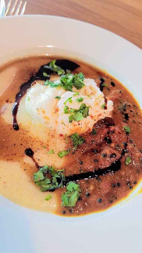 Aramsey Spiced Brunch with Ruchikala and Public Provisions: Saruu Kanji, a brown butter congee with a tamarind fenugreek tomato stew that includes 17-18 spices toasted to different degrees and all topped with an egg