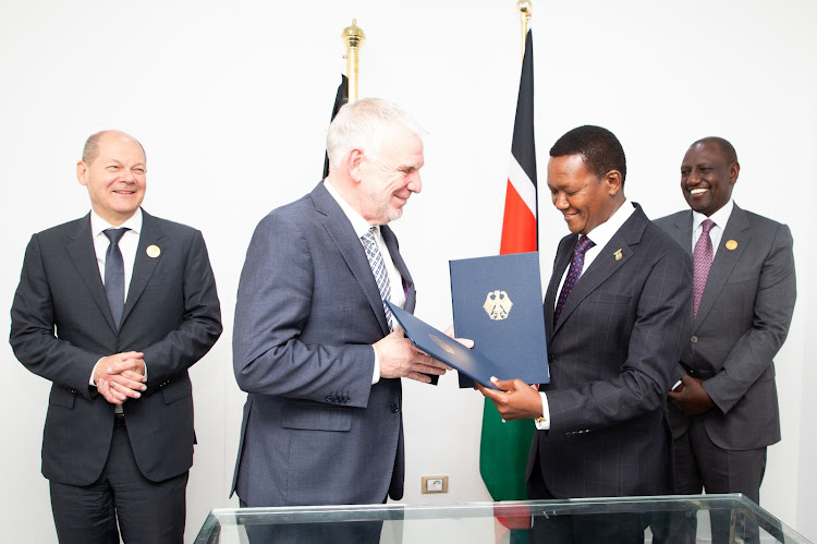 President William Ruto, German Chancellor Olaf Scholz, Foreign Affairs CS Alfred Mutua and another official during the signing of a joint declaration on Climate and Development Partnership in Shamar El Sheikh, Egypt.