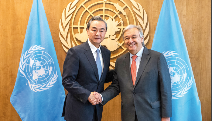 Chinese Foreign Minister Wang Yi shakes hands with United Nations Secretary General Antonio Guterres at UN headquarters in New York.