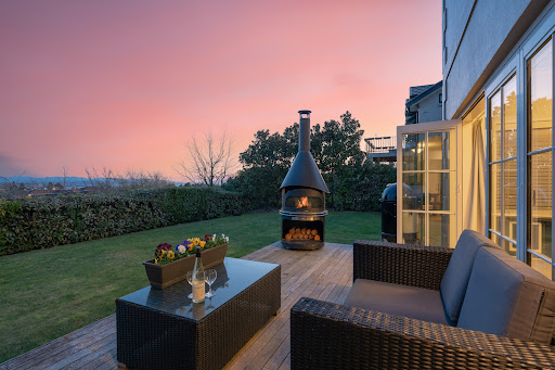 Wooden terrace with outdoor lounge and fire pit in this luxury apartment / penthouse for sale in Taupō