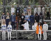 Designer Riccardo Tisci poses backstage with models wearing creations from the Burberry spring-summer 2021 collection during the London Fashion Week.