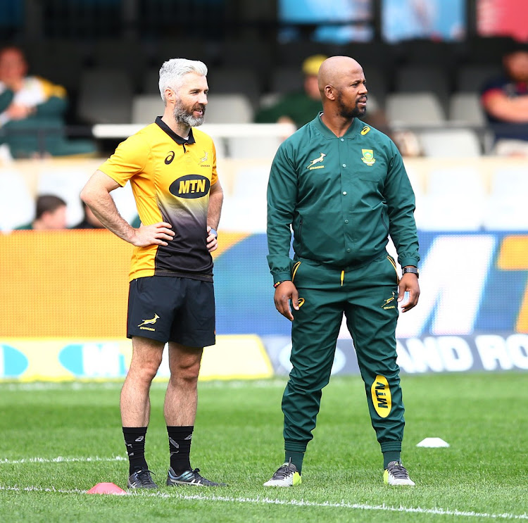 The Springboks assistant coach Mzwandile Stick (R) watches on during the national rugby team's training session on September 5 2018 in Brisbane alongside head of athletic performance Aled Walters (L) ahead of South Africa's third Rugby Championship match against Australia on September 8 2018.