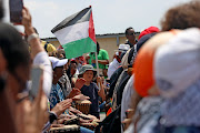 A young boy seen amongst human rights activists in solidarity with Palestinians. 