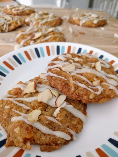 Chewy oatmeal cookies with apricots, coconut & almonds covered in a white chocolate drizzle