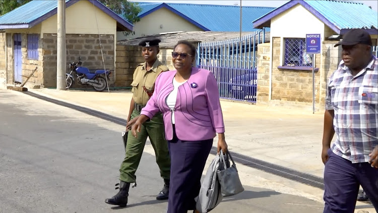 Vihiga Chief Officer Noel Malanda being taken to the vehicle by Detective attached to EACC officials during arrest