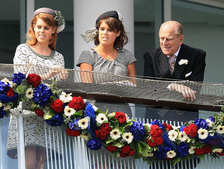 Princesses Beatrice (left) and Eugenie with their late grandfather, Prince Philip.