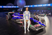 Daniel Ricciardo poses for a photo with the Visa Cash App RB VCARB 01 at the Visa Cash App RB livery launch event in Las Vegas, Nevada, on February 8 2024.