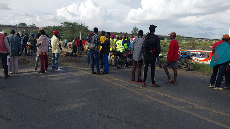 Members of the public mill around an accident scene along Nairobi - Namanga highway in Athi River, Machakos County on March 30, 2024.