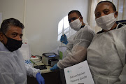 Prof Anil Chuturgoon, Dr Veron Ramsuran and Dr Lungi Mkhize-Kwitshana from the UKZN College of Health Sciences receive the new equipment for Covid-19 testing.