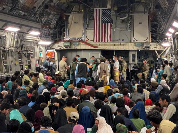 A newborn baby is looked after prior taking off with other Afghan evacuees on a C-17 Globemaster III at a Middle East staging area on August 23 2021.