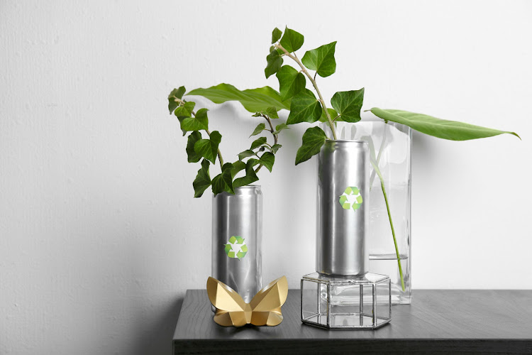 Adding vases or upcycled containers filled with garden greenery will give any tired room a lift.